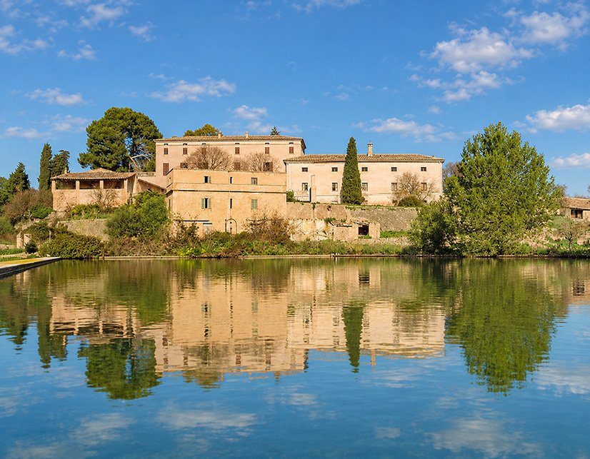 Historic possessió reflected in the water of its reservoir, Mallorca